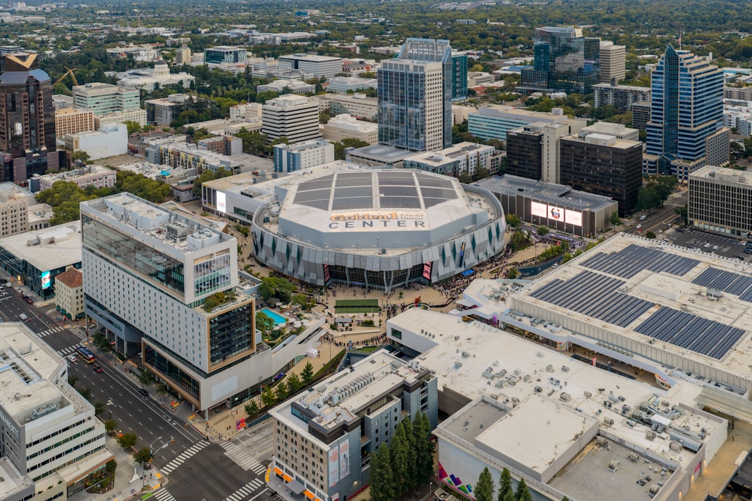 Aerial view of a modern cityscape with a large arena.