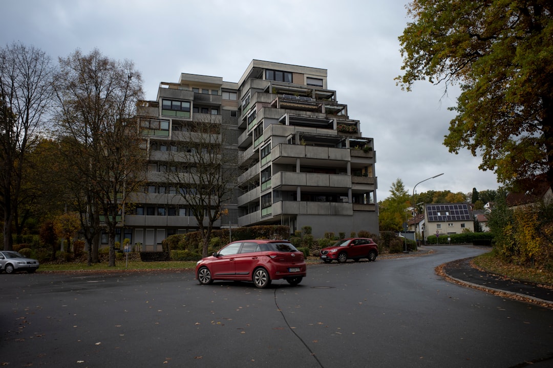 Modern apartment building with cars on road