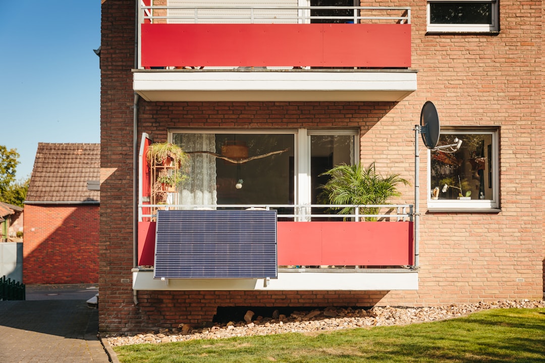 Red balcony screens on brick apartment building