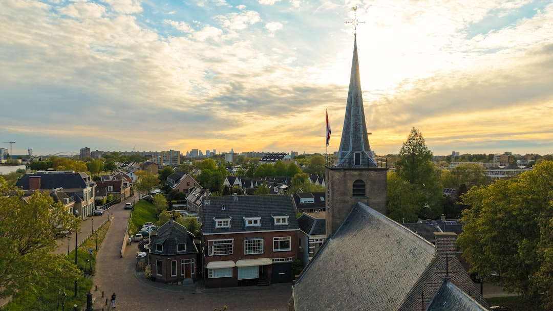 Old church steeple overlooking a european town at sunset